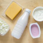 flat lay of dairy products on wooden background top view